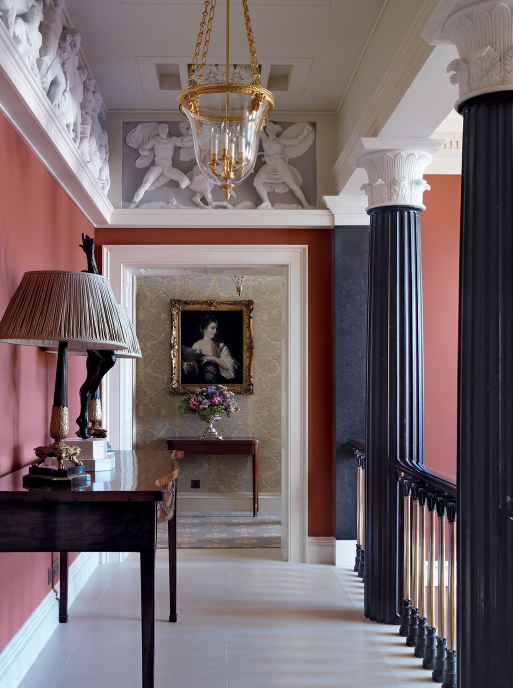 The gallery above the new hall is lit by a chandelier and lamps designed by Mark Gilette.