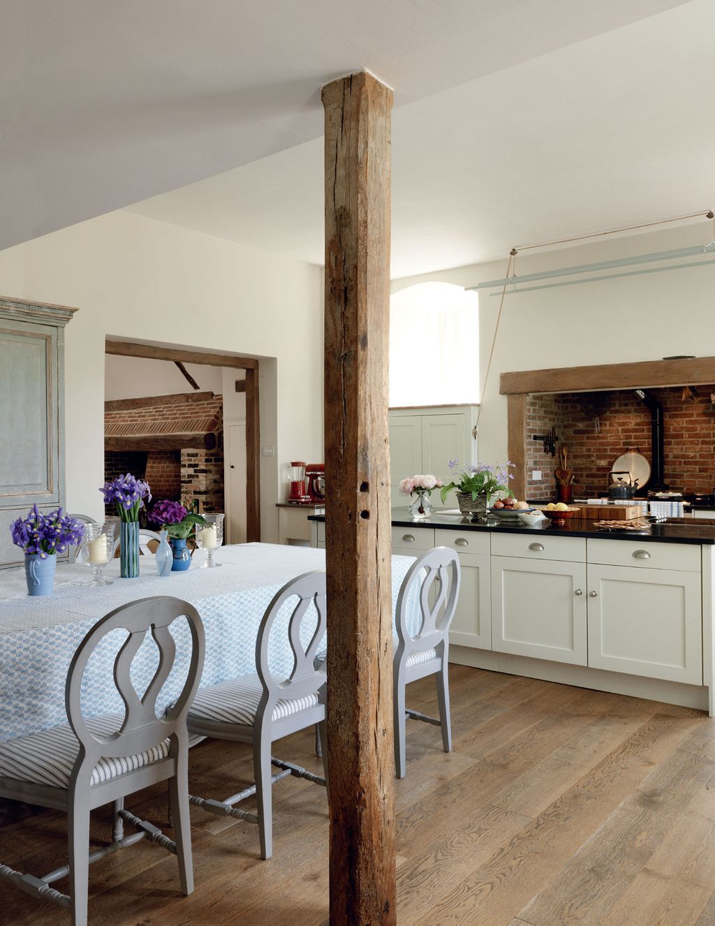Image may contain Furniture Chair Interior Design Indoors Flooring Room Wood Hardwood Floor and Kitchen
