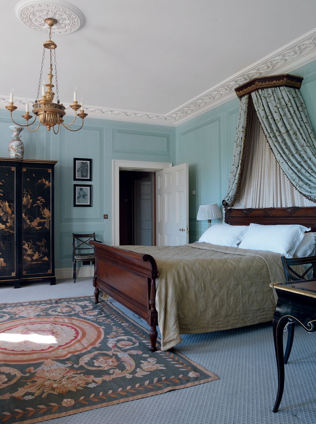 This bedroom panelling is painted in a custommixed shade by Mark Gillette which complements the wallpaper in the ensuite...