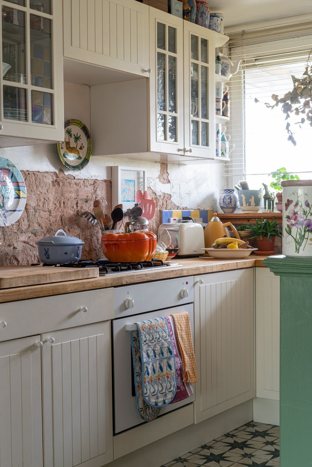 The kitchen is Ikea my husband installed it himself. The plates hanging on the wall are from Anthropologie and by Gavin...