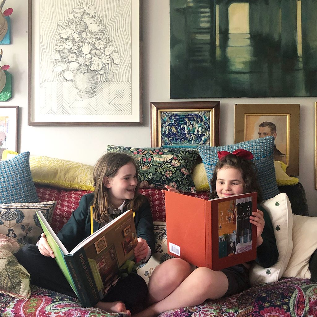 Sholto and Esmeralda researching interior design on the sofa.