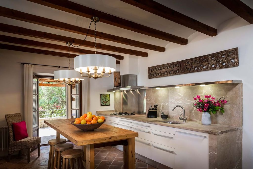 Image may contain Room Indoors Kitchen Interior Design Furniture Wood Living Room Kitchen Island and Dining Table