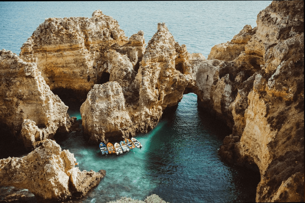 Image may contain Nature Water Outdoors Ocean Sea Cave Vehicle Transportation Boat Shoreline Coast and Cove