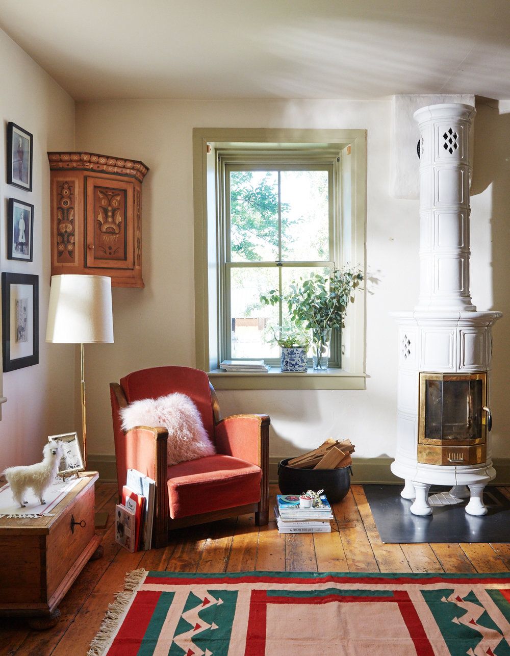 Image may contain Furniture Indoors Living Room Room Home Decor Rug Chair and Hearth