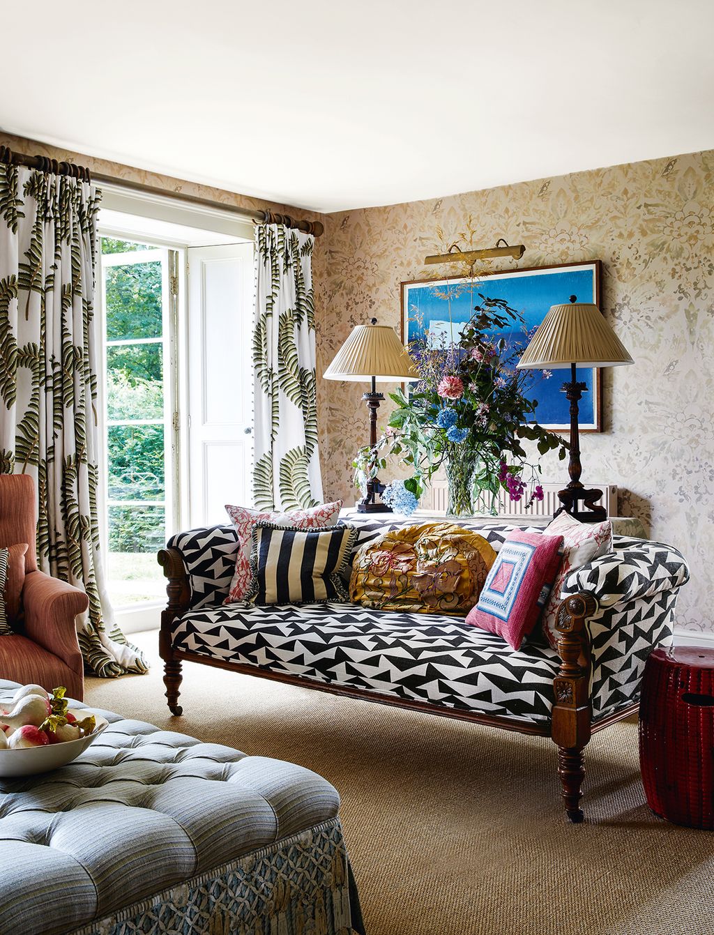 The curtains are in ‘Fernerie and the 19thcentury fruitwood sofa is covered in ‘Puzzled jacquard in chess both from Madeaux.