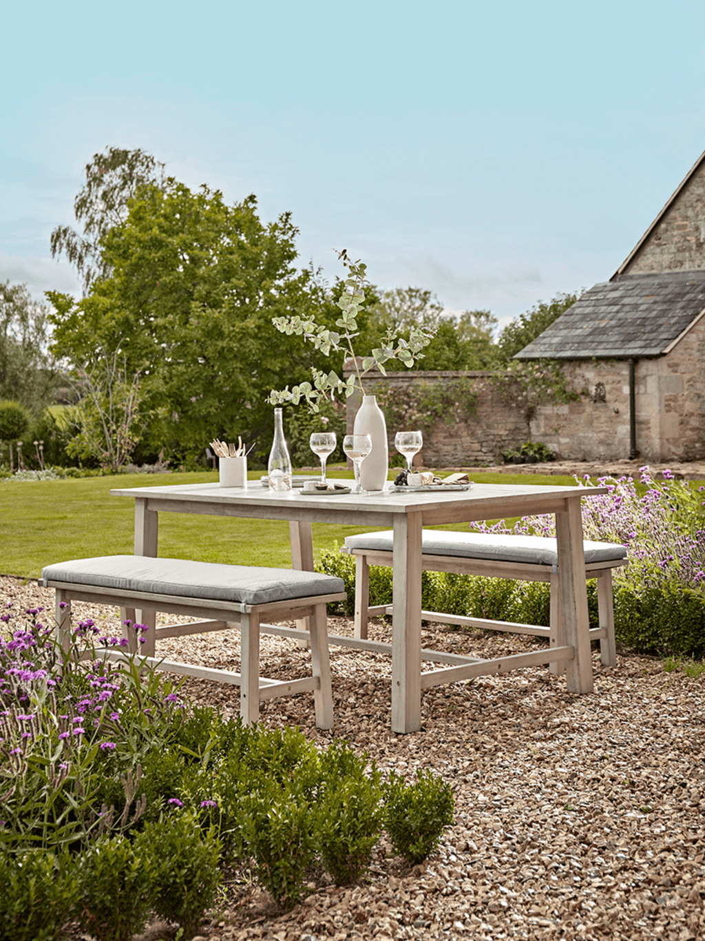 Image may contain Furniture Table Plant Grass Dining Table and Bench