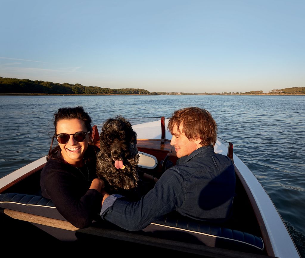 Image may contain Human Person Sunglasses Accessories Accessory Furniture Transportation Vehicle Water and Sitting