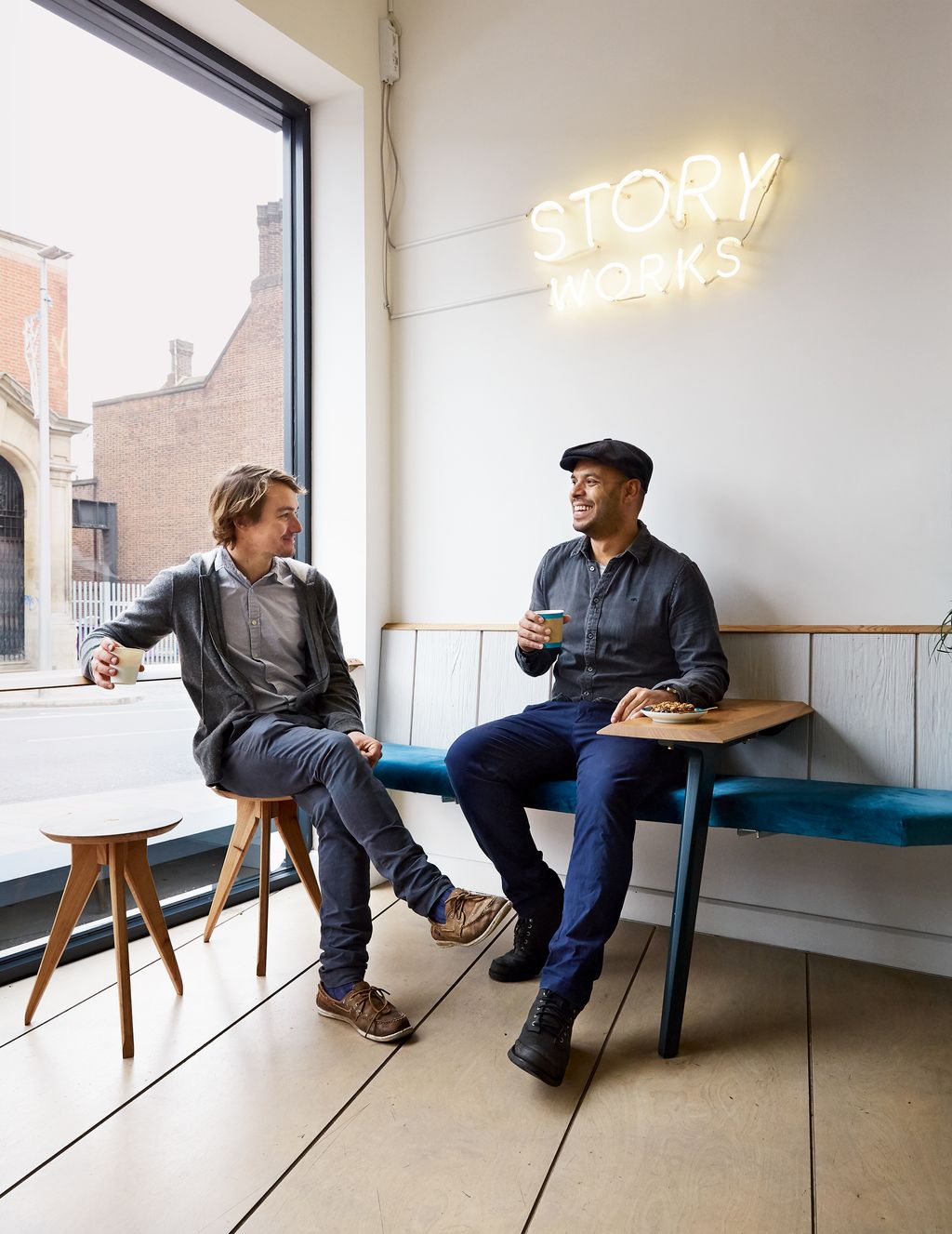 Image may contain Sitting Human Person Clothing Shoe Footwear Apparel Flooring Pants and Furniture