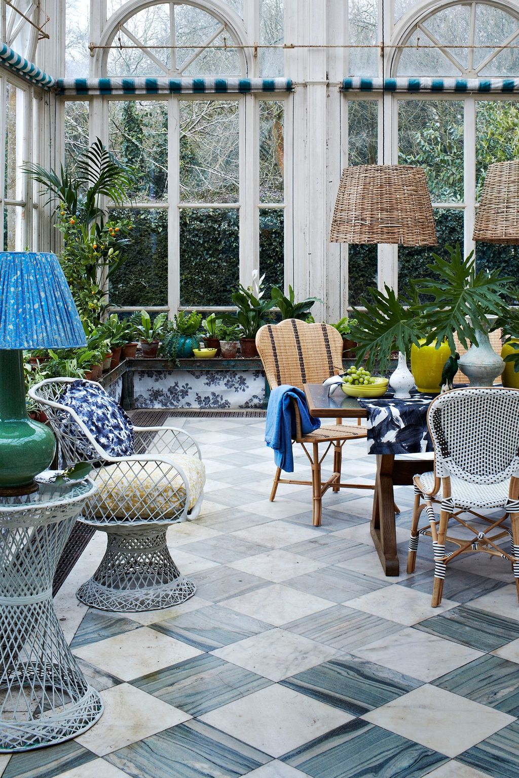 A conservatory can add a wonderful space to relax and entertain in. A mix of botanical prints a patterned tiled floor...