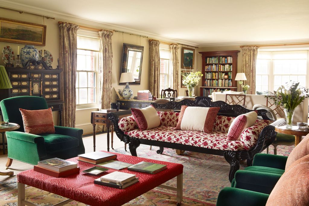 An AngloIndian sofa covered in 'Antalya' an embroidered linen by Vaughan and four armchairs upholstered in a green...