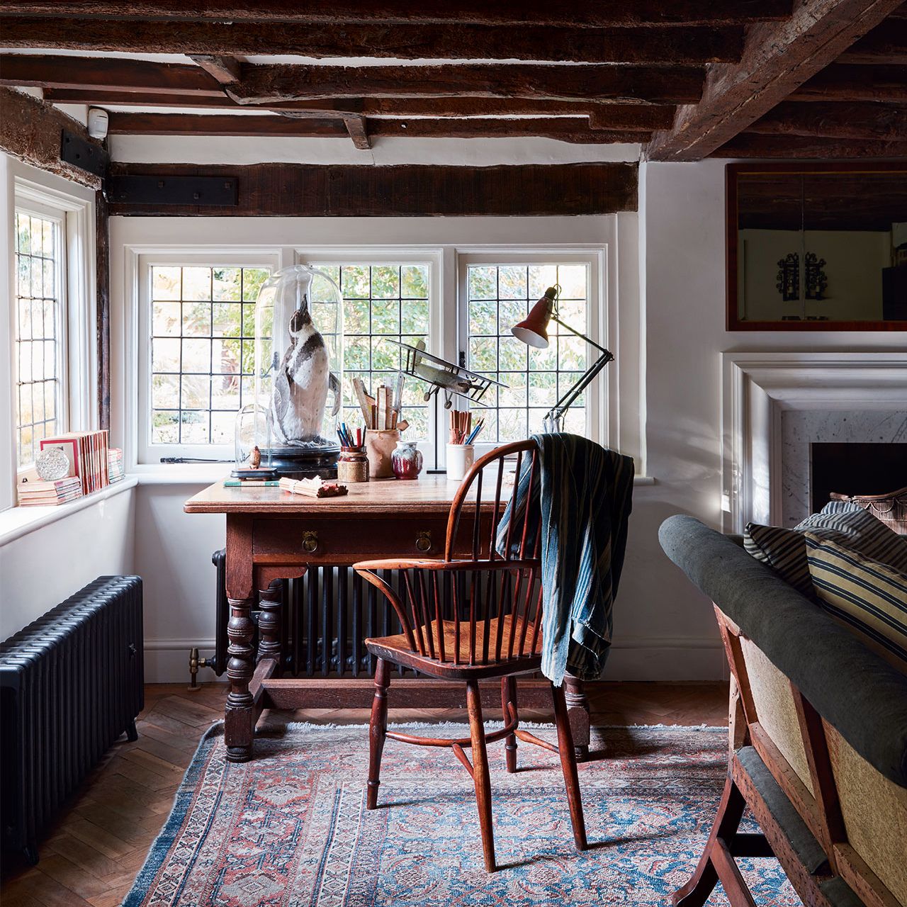 Image may contain Furniture Chair Indoors Living Room Room Housing Building Wood Flooring Table and Rug