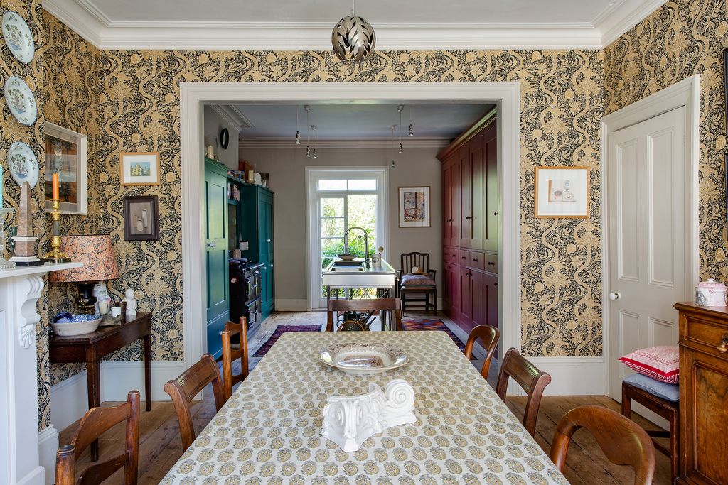 Image may contain Room Indoors Interior Design Flooring Home Decor Living Room Dining Room Rug and Furniture