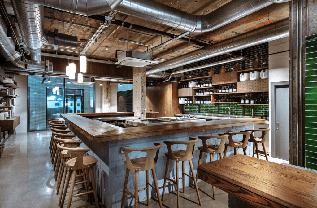 Image may contain Wood Plywood Hardwood Furniture Restaurant Kitchen Island Indoors Pub Chair and Cafeteria