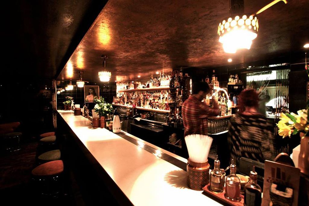 Image may contain Human Person Pub Bar Counter Bottle Drink Alcohol Beverage Wine Lighting and Wine Bottle