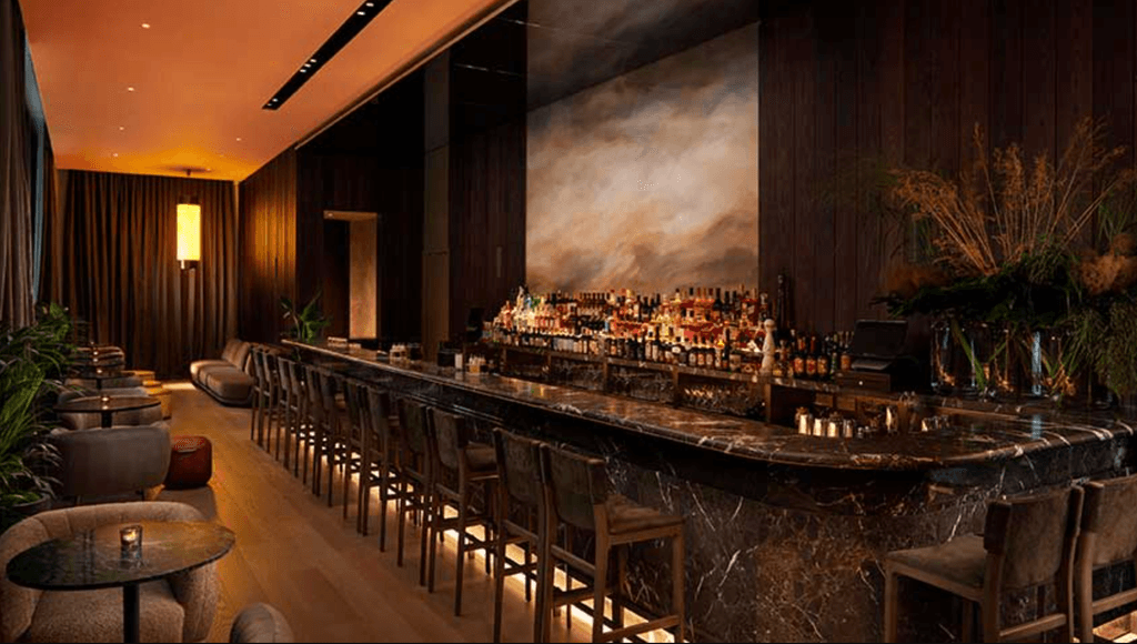 Image may contain Drink Alcohol Wine Beverage Pub Bottle Furniture Chair Bar Counter and Wine Bottle