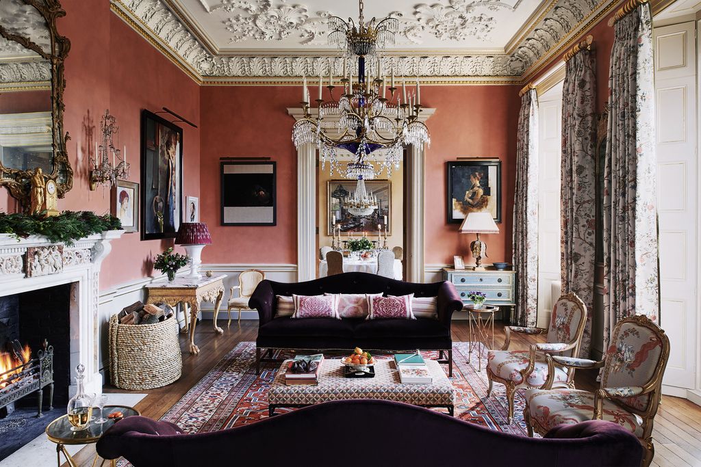 Image may contain Living Room Indoors Room Furniture Interior Design Rug Couch Lamp Chandelier and Chair