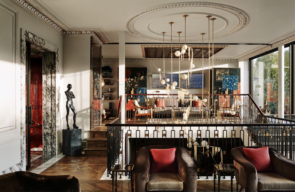 Image may contain Furniture Couch Living Room Room Indoors Flooring Human Person Interior Design Floor and Wood