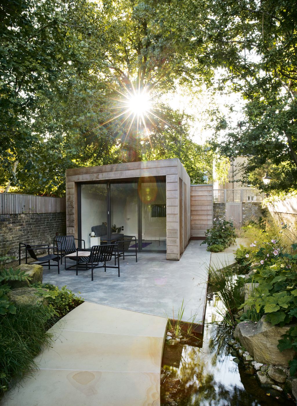 In the woodland area at the far end of the garden the waterway widens out into a stream shaped with boulders and...