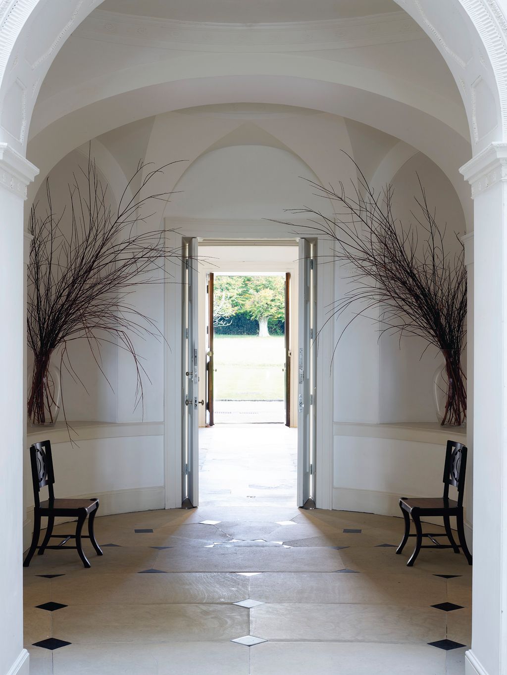 Image may contain Flooring Floor Building Architecture Arched Arch Furniture and Chair