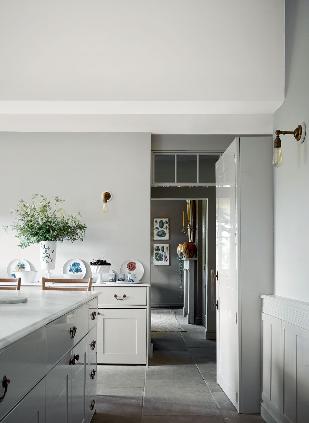 In the kitchen Katharine chose Farrow Balls ‘Shaded White for the walls of this calm paredback space in which...