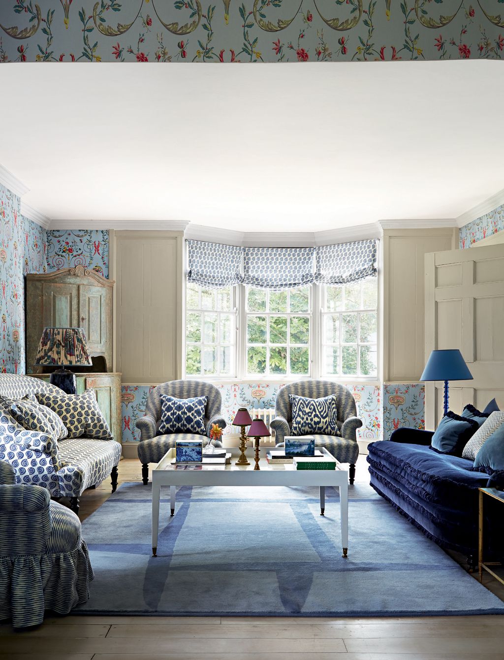 Image may contain Furniture Living Room Indoors Room Couch Rug Table and Chair