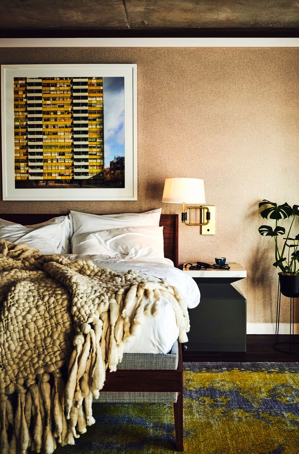 Image may contain Room Bedroom Indoors Furniture Bed Living Room Interior Design Lamp Table Lamp and Dorm Room