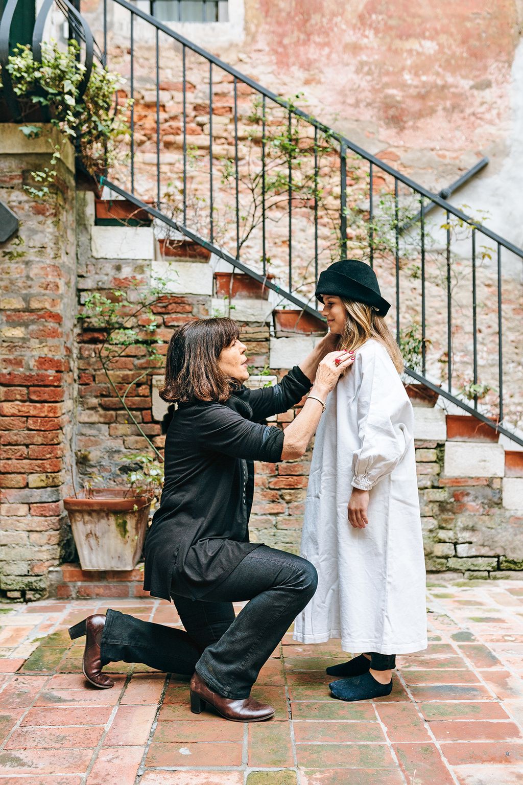 Giovanna Cordova the teacher and director at Servanes theatre school helps a local schoolgirl with her costume in the...