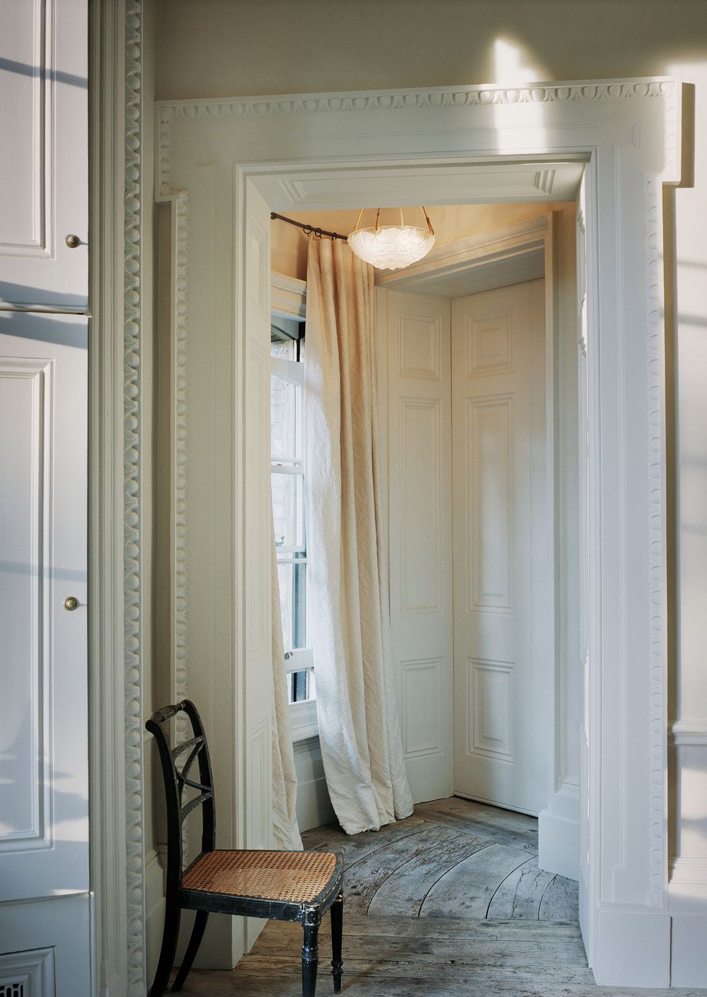 Image may contain Furniture Chair Indoors Room Door Floor and Flooring