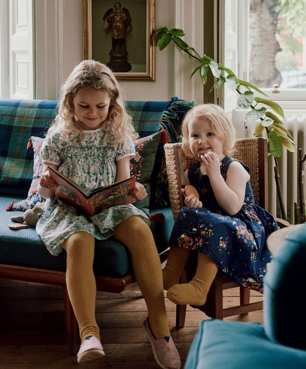 Image may contain Furniture Couch Human Person Wood Footwear Clothing Shoe Apparel Sitting and Hardwood