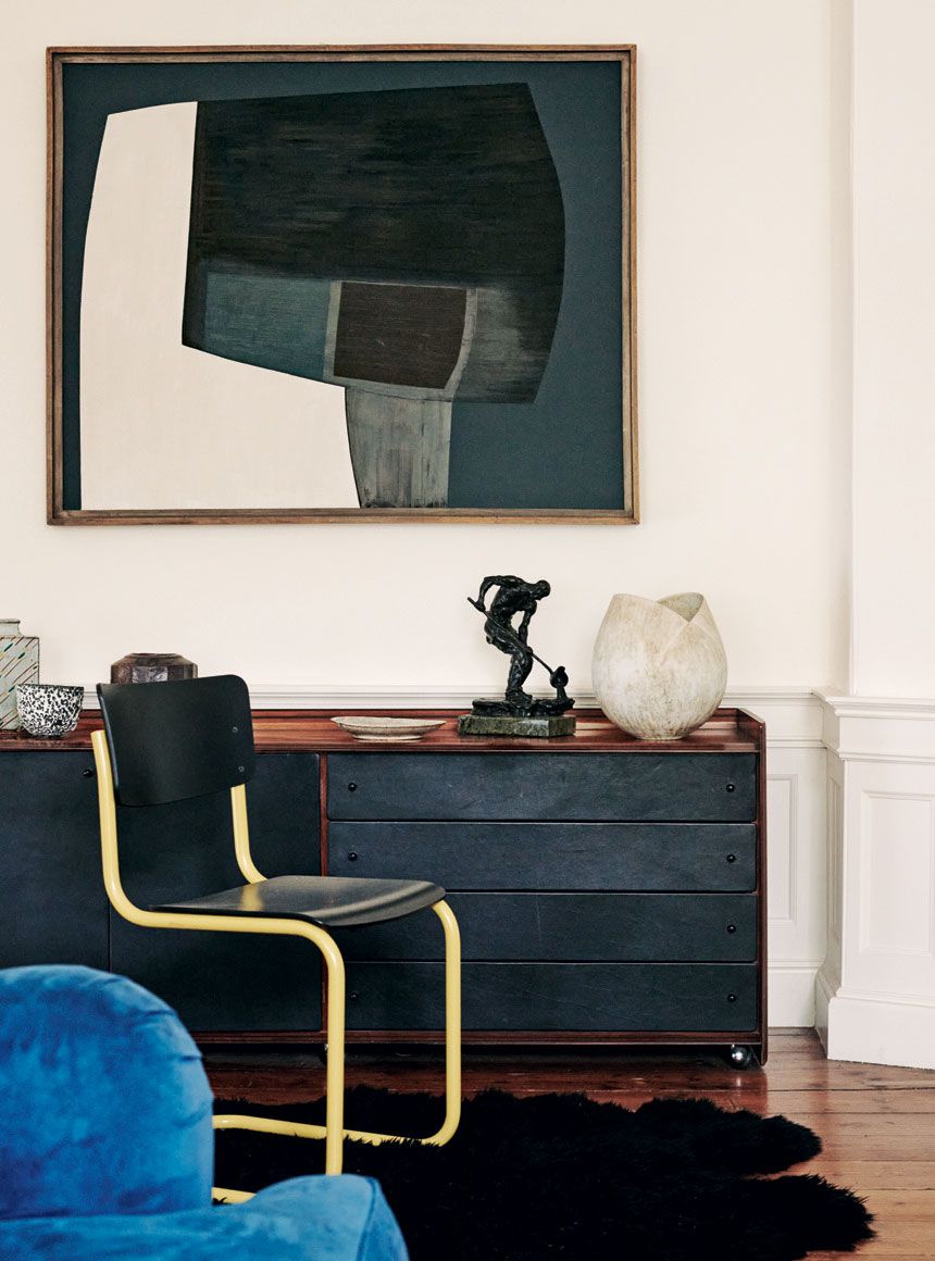 In a corner of the sitting room in Emilys family home a metal sculpture by Albert Toft and ceramic vessel by John Ward...