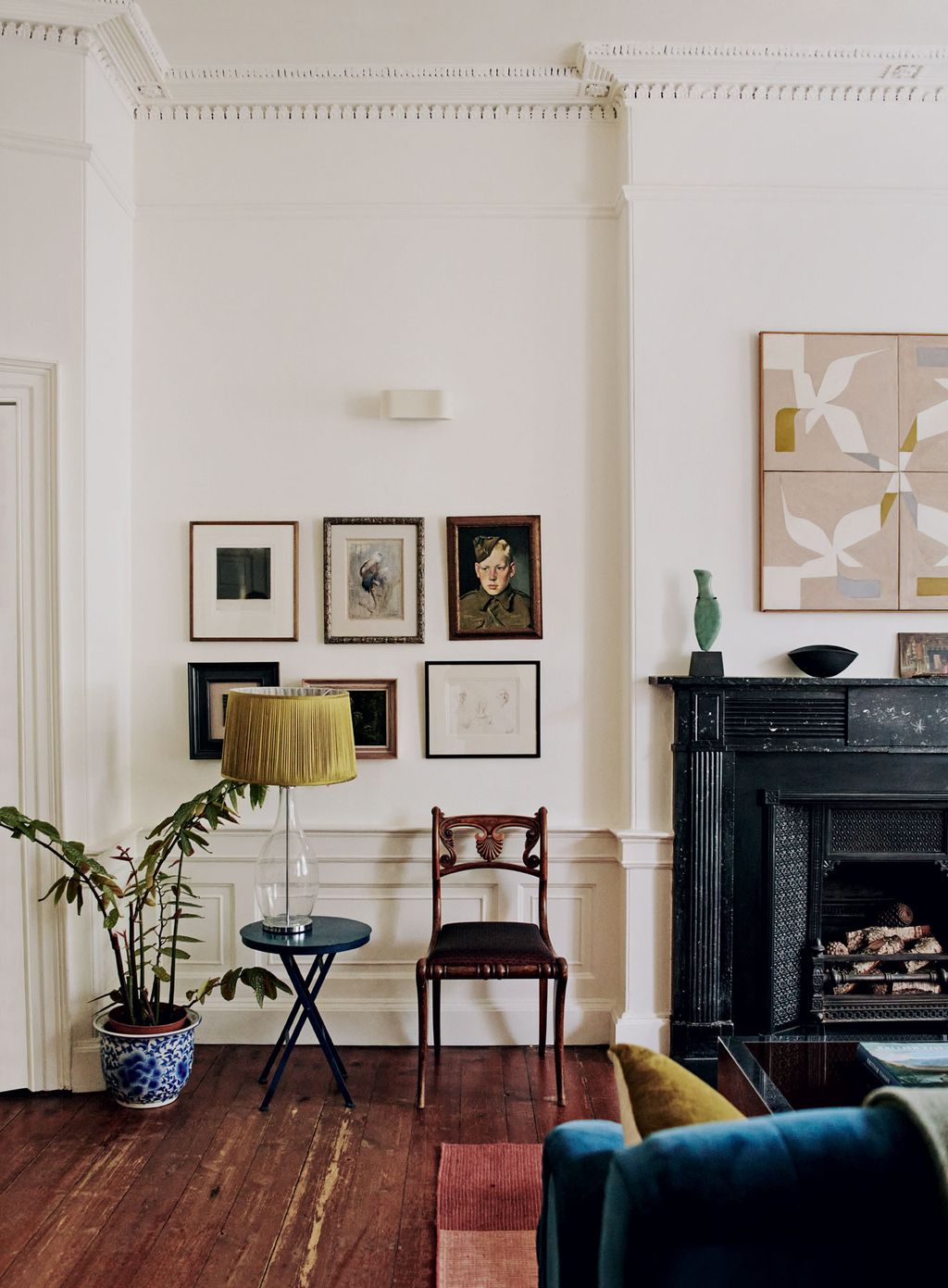 Image may contain Indoors Furniture Chair Interior Design Living Room Room Fireplace Lamp Table Lamp and Hearth