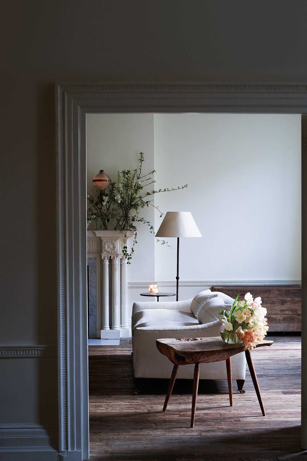 Image may contain Living Room Indoors Room Flooring Interior Design Furniture Couch Plant Wood Hardwood and Table