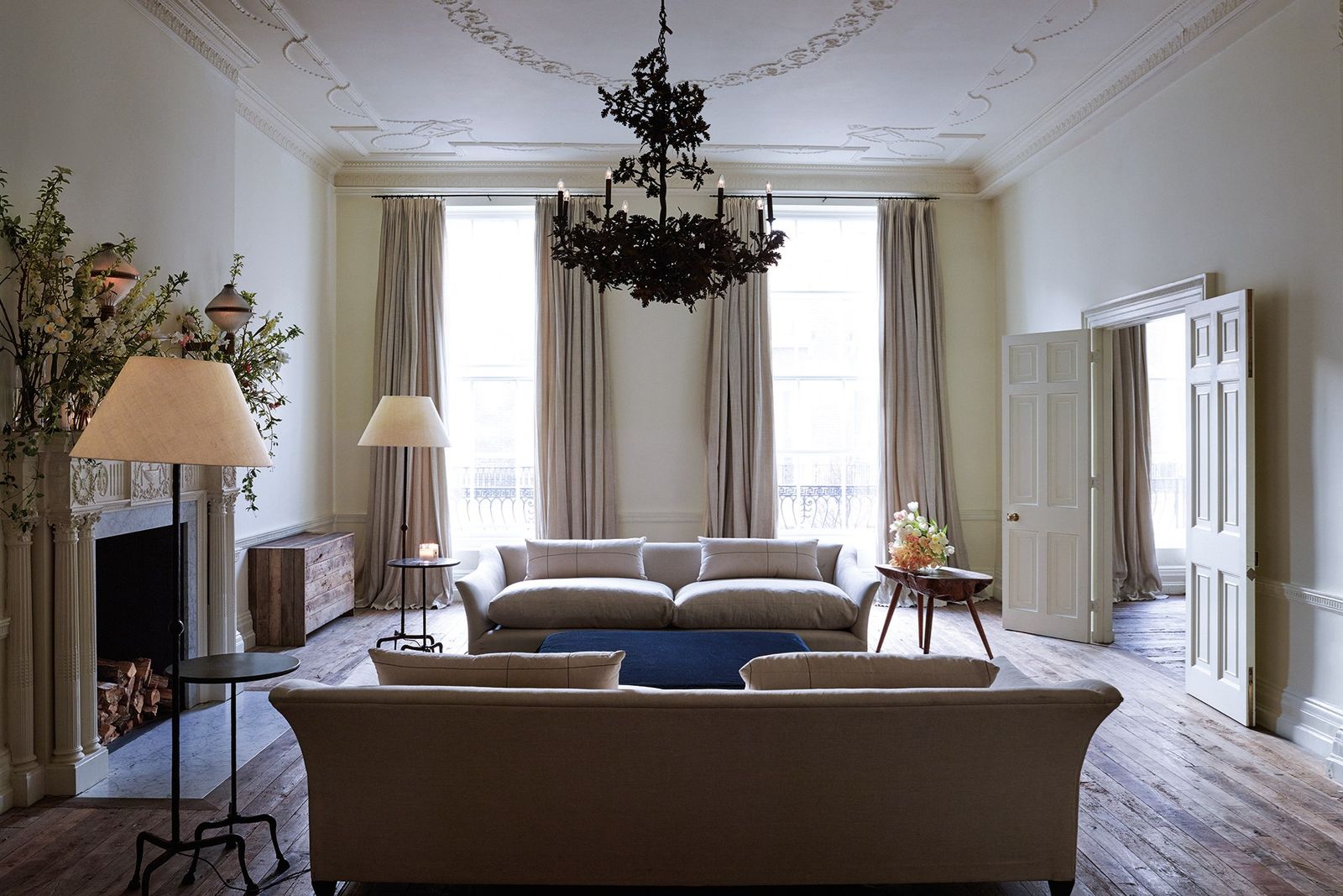 Image may contain Living Room Indoors Room Furniture Couch Lamp and Chandelier