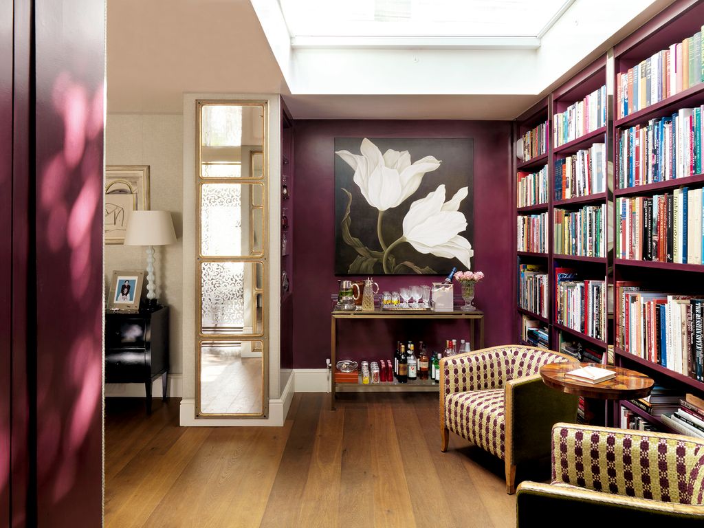 Strategically placed mirrors in the skylit hall reflect the garden.
