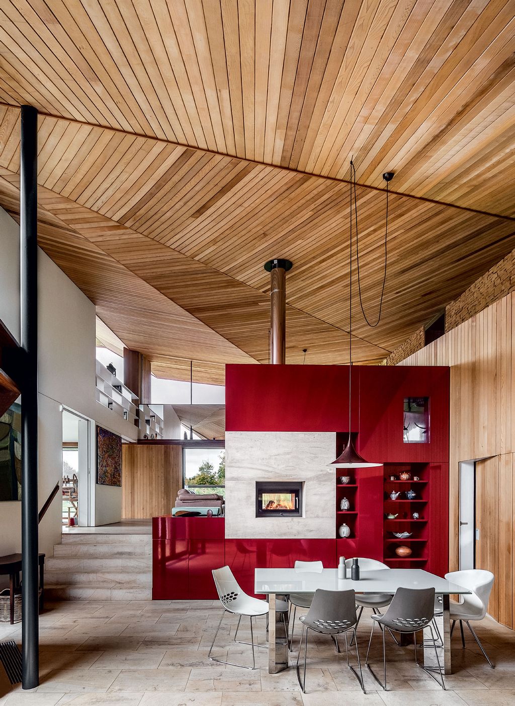 Steps lead up to the sitting area with views of the garden and to the room used for weaving and music.