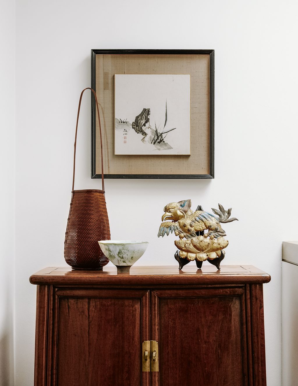 A Tibetan gilt plaque is among the objets on a sixteenthcentury Chinese cupboard on the landing.