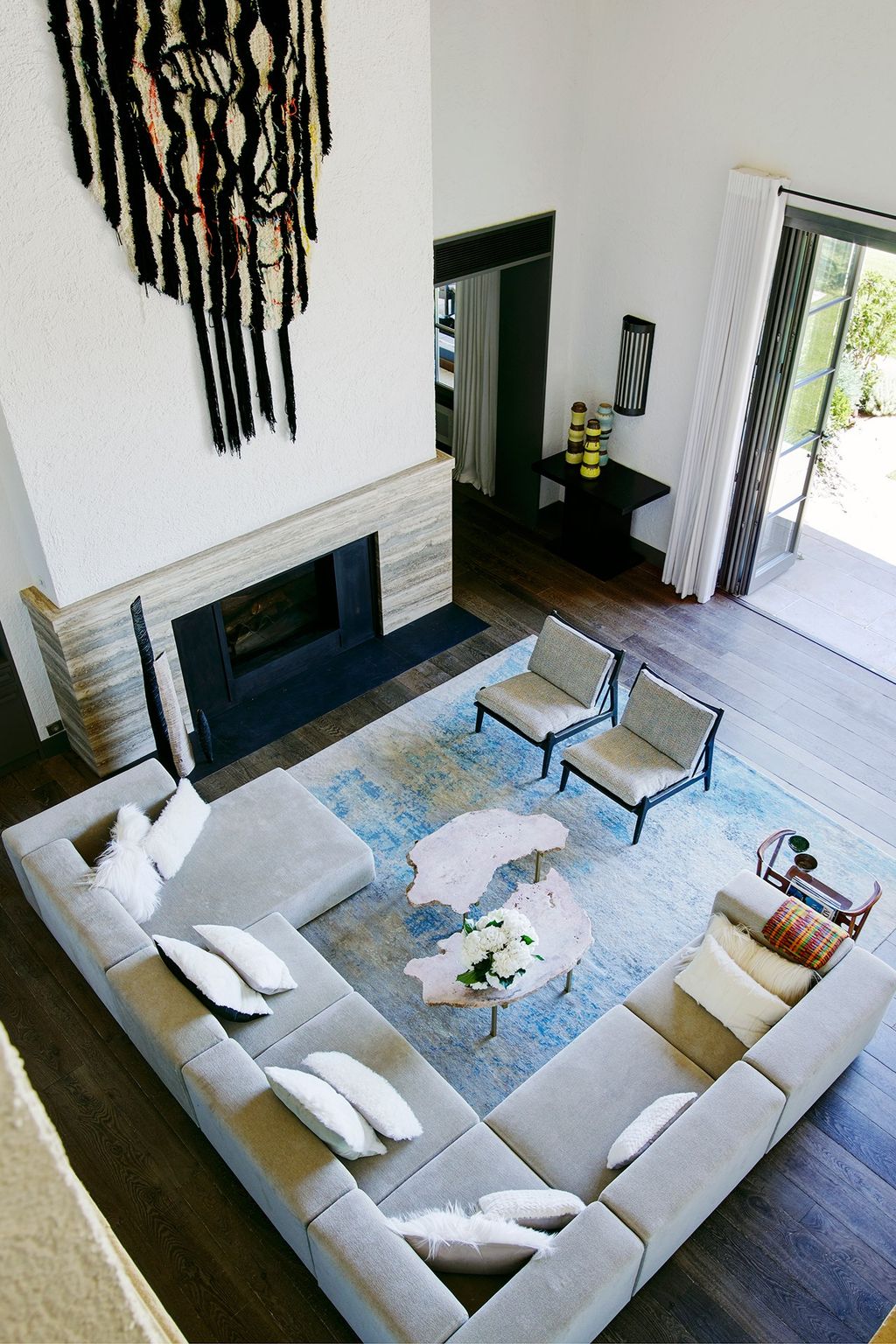 Image may contain Living Room Room Indoors Furniture Interior Design Couch Rug Flooring Table Cushion and Pillow