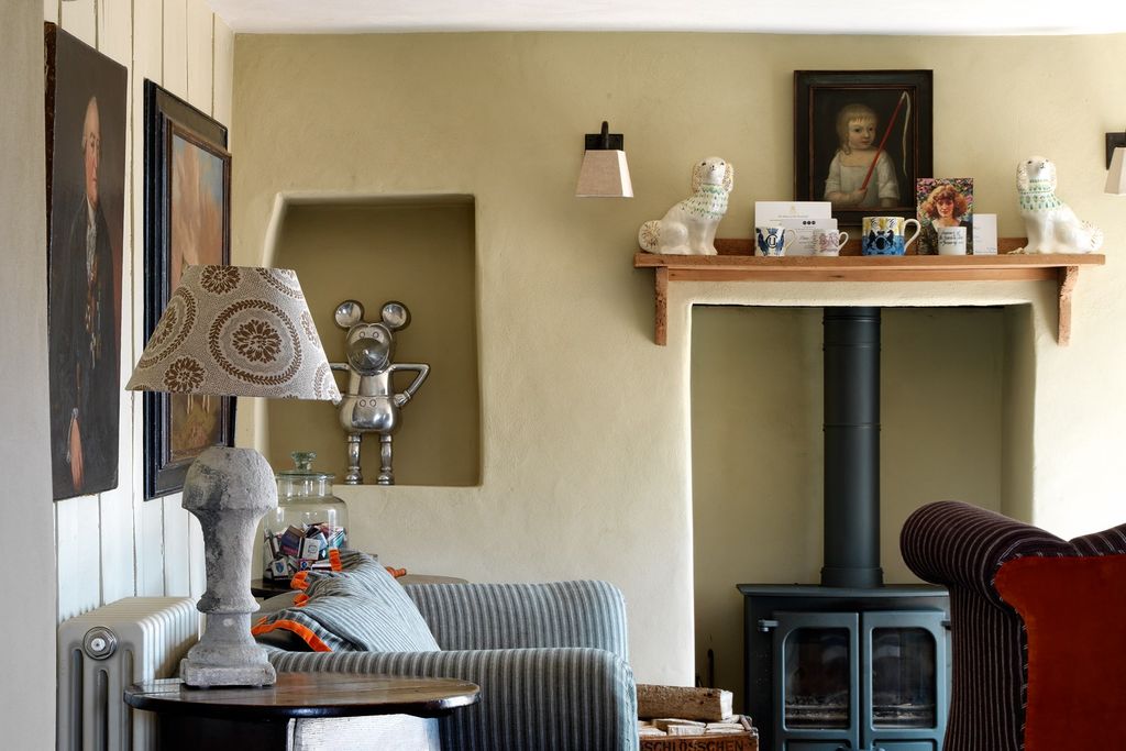 Image may contain Living Room Room Indoors Furniture Couch Human Person Shelf Interior Design Lamp and Table Lamp