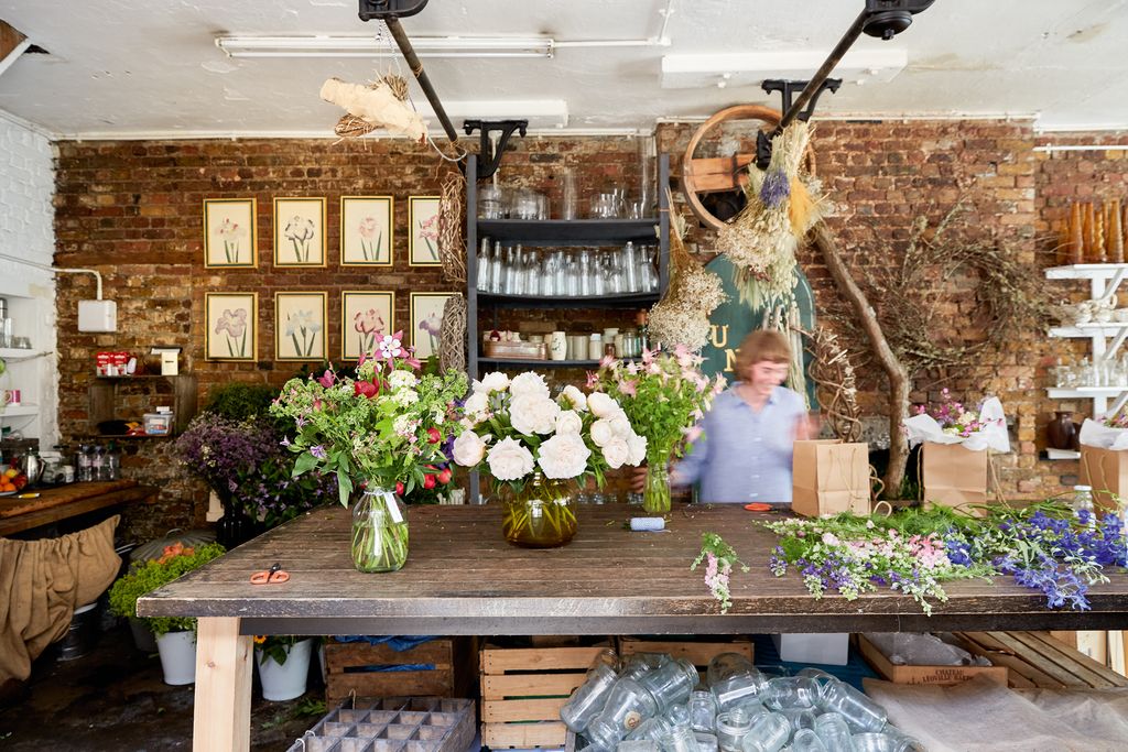 Image may contain Human Person Plant Flower Flower Arrangement Blossom Flower Bouquet Church Altar and Architecture