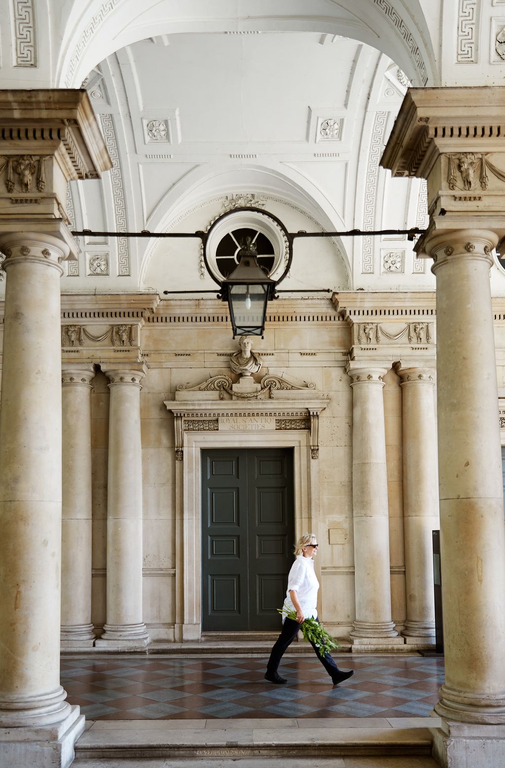 Image may contain Human Person Architecture Building Door Floor Footwear Clothing Shoe Apparel and Flooring