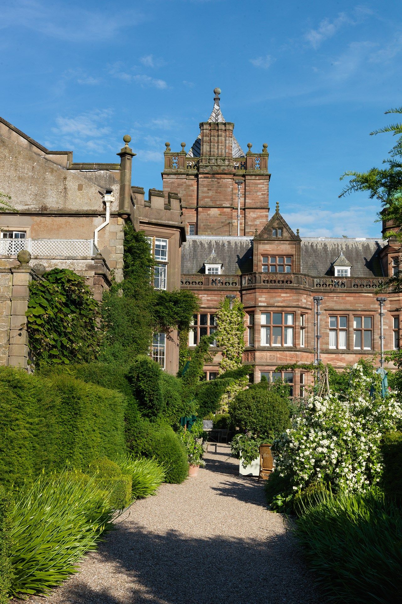 Image may contain Outdoors Architecture Building Plant Garden Spire Tower Steeple Bush Vegetation and Arbour