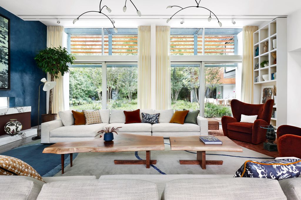 Image may contain Furniture Table Living Room Room Indoors Coffee Table Rug Cushion and Pillow