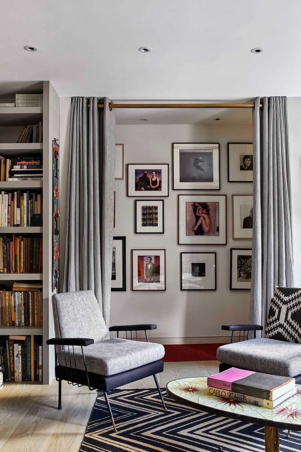 Image may contain Furniture Chair Bookcase Shelf Living Room Indoors Room Interior Design and Rug