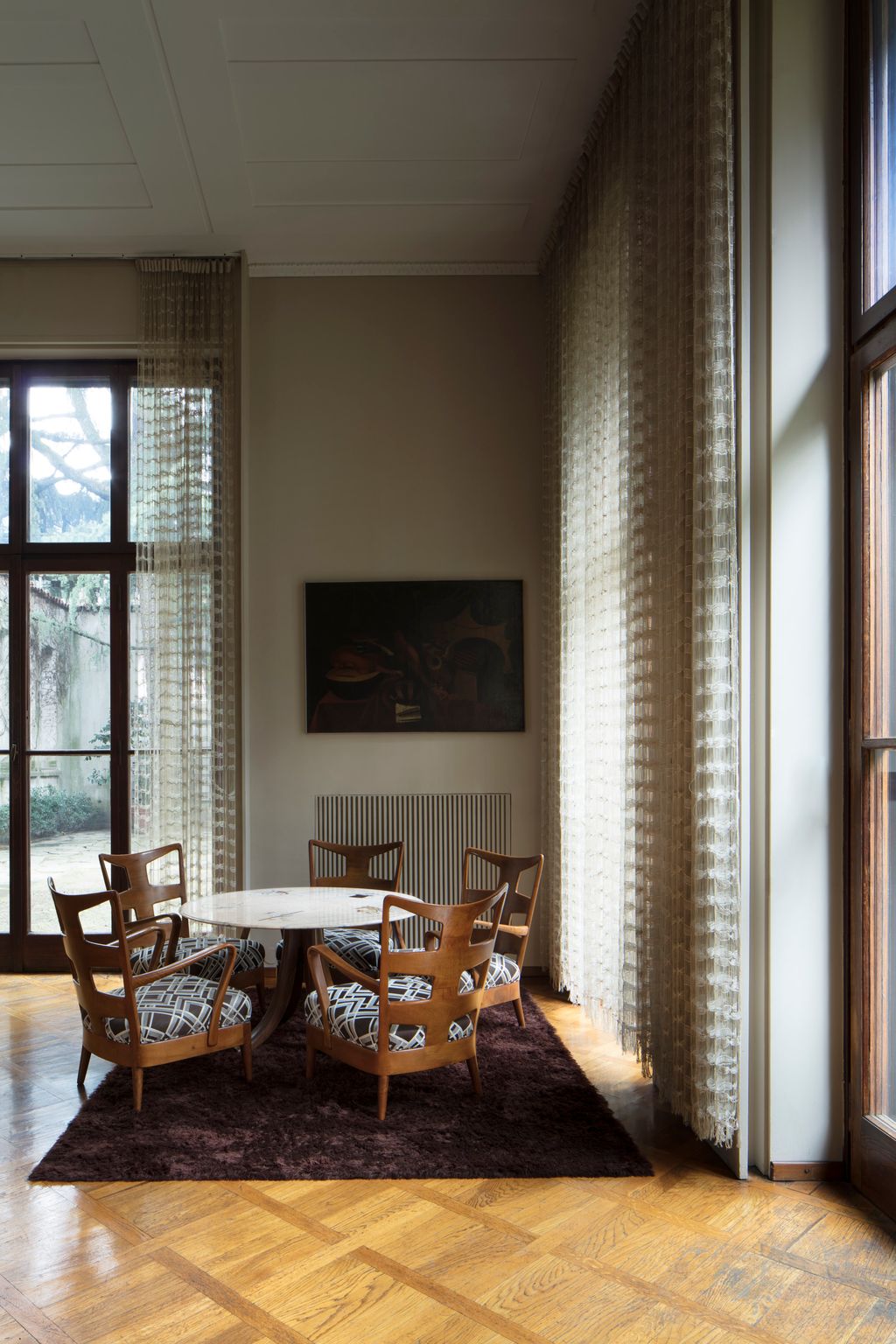 Image may contain Furniture Chair Home Decor Wood Flooring Hardwood Floor Dining Table Table and Interior Design