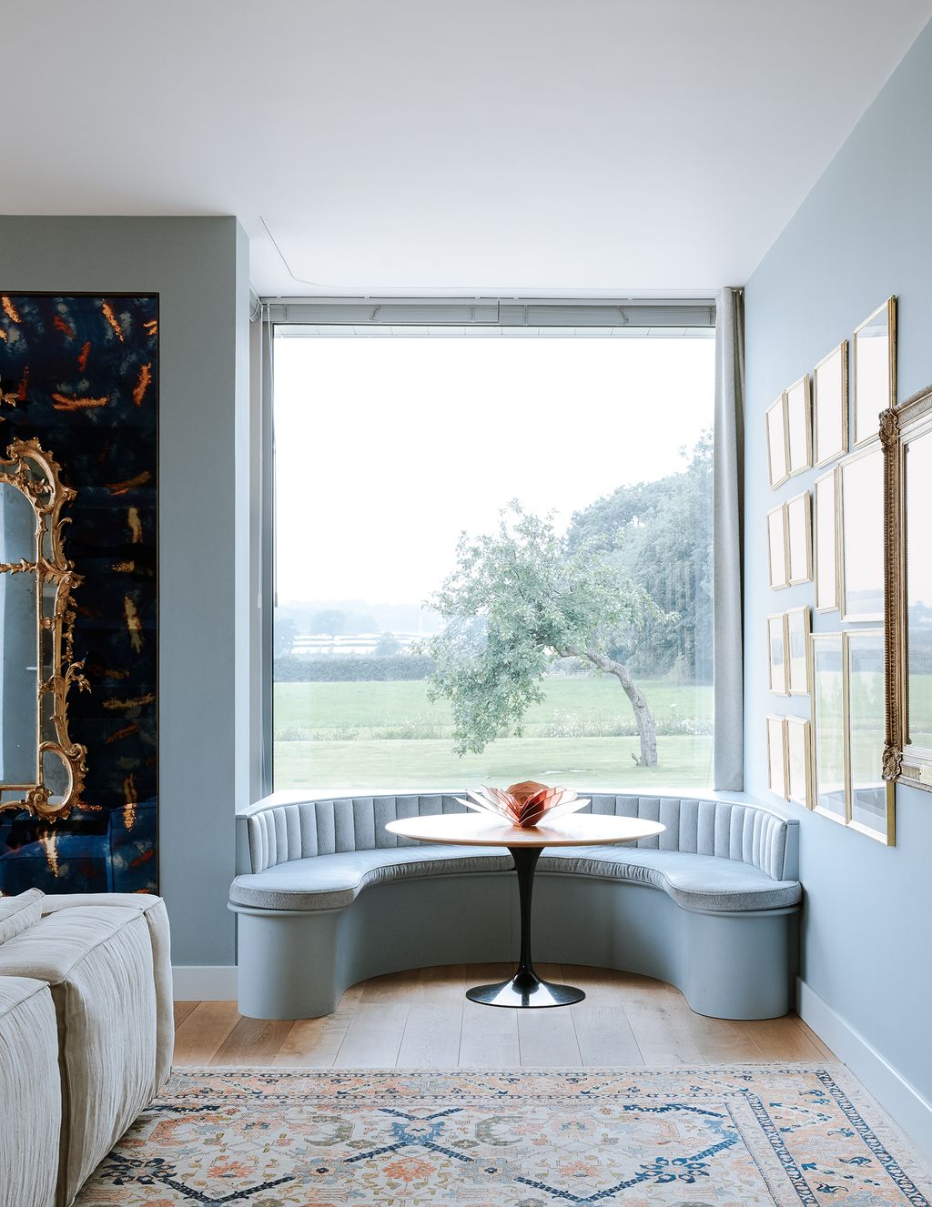 Image may contain Furniture Living Room Indoors Room Interior Design Rug and Picture Window