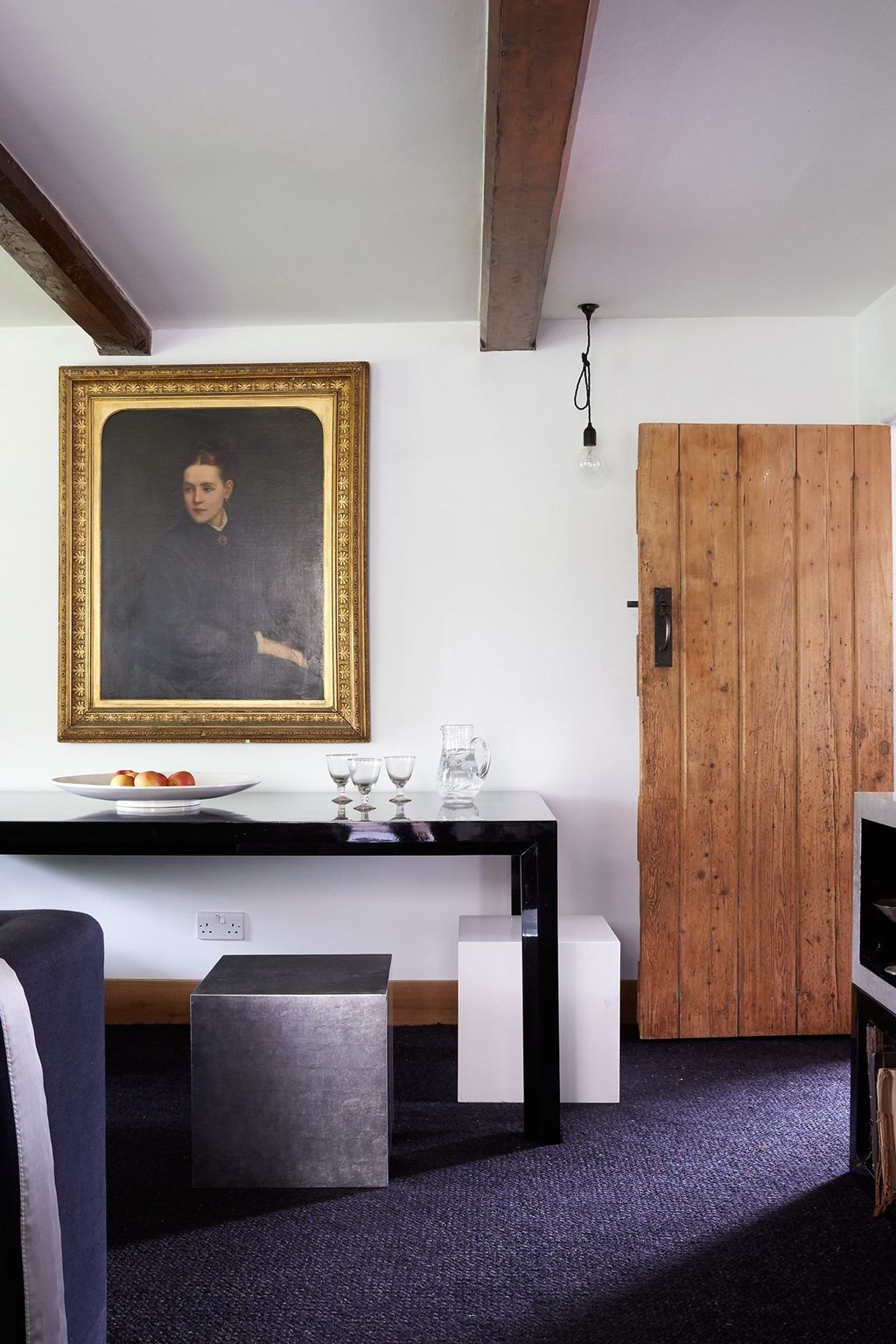 Image may contain Furniture Indoors Interior Design Human Person Wood Corner Table Room Living Room and Sideboard