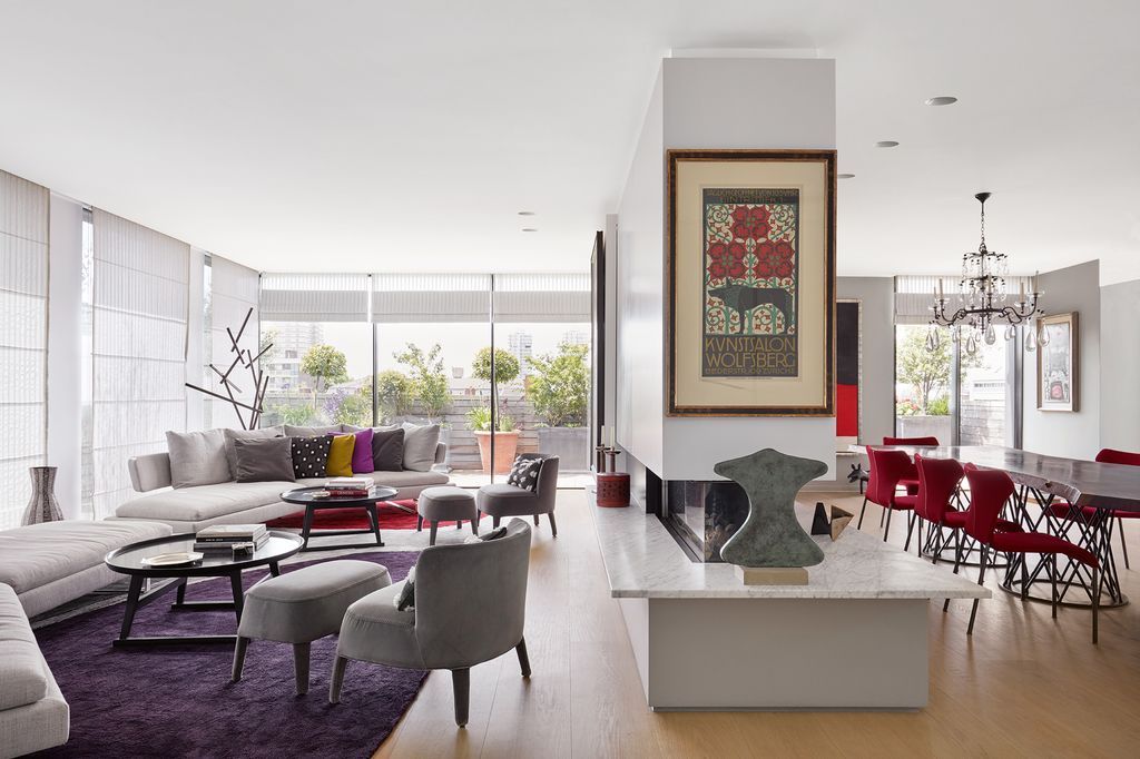 The wall that divides the living space presented a challenge for David who introduced curves into the sitting area using...