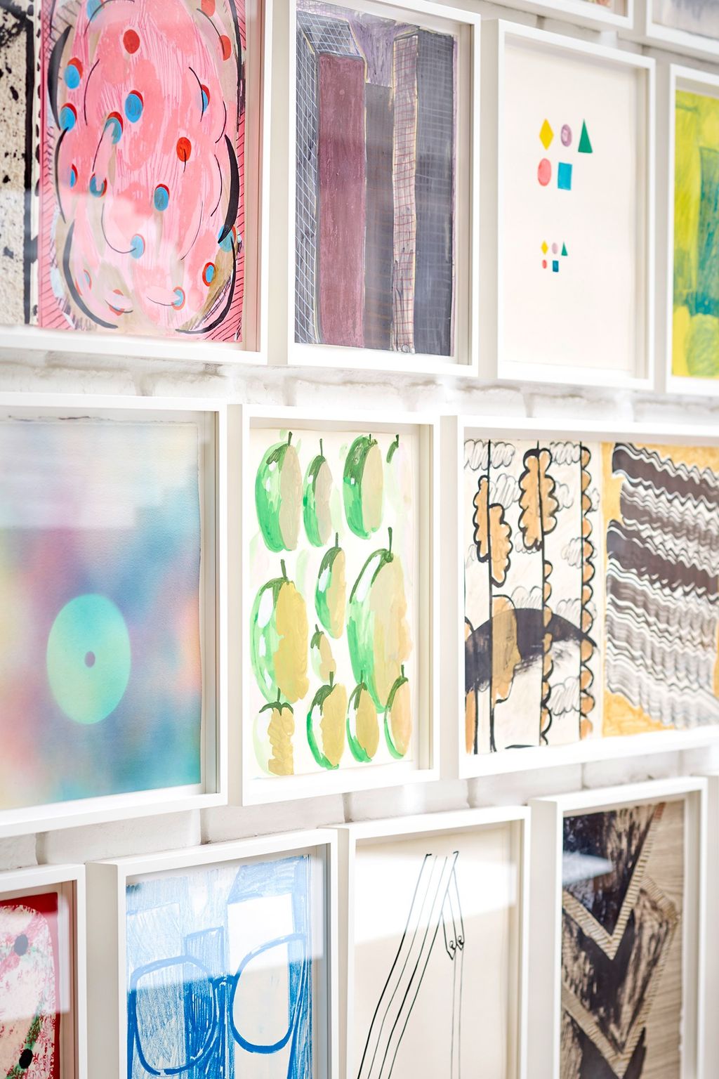 A wall of Phoebe Unwin artworks in the dining and living room.