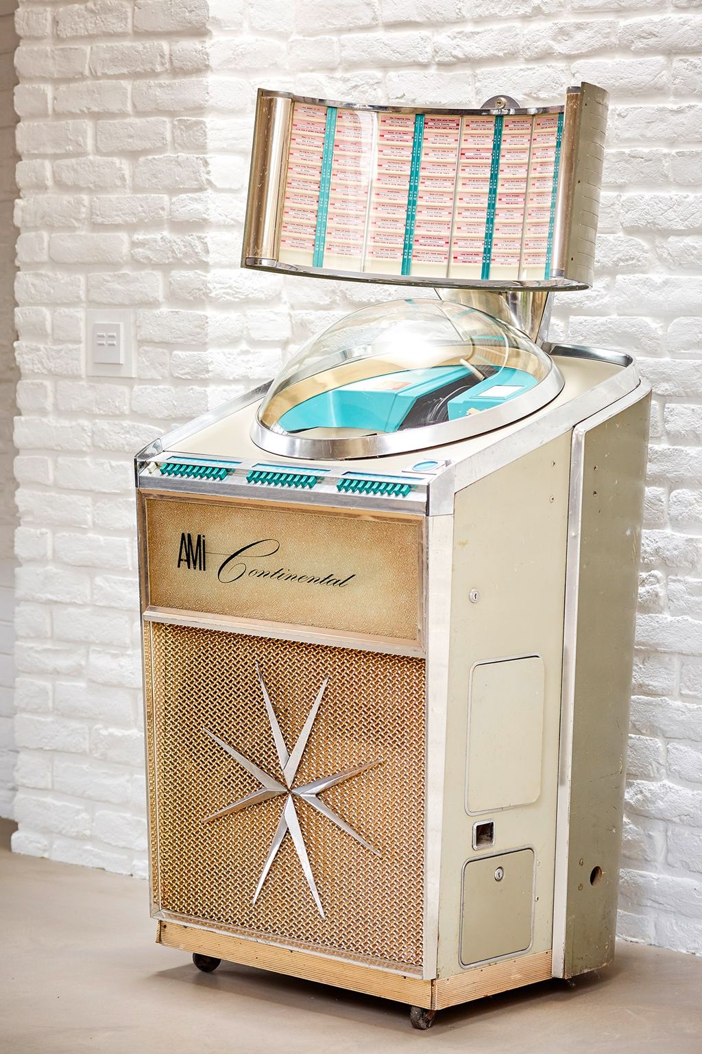 A jukebox with pastel colours compliments the white brick walls.