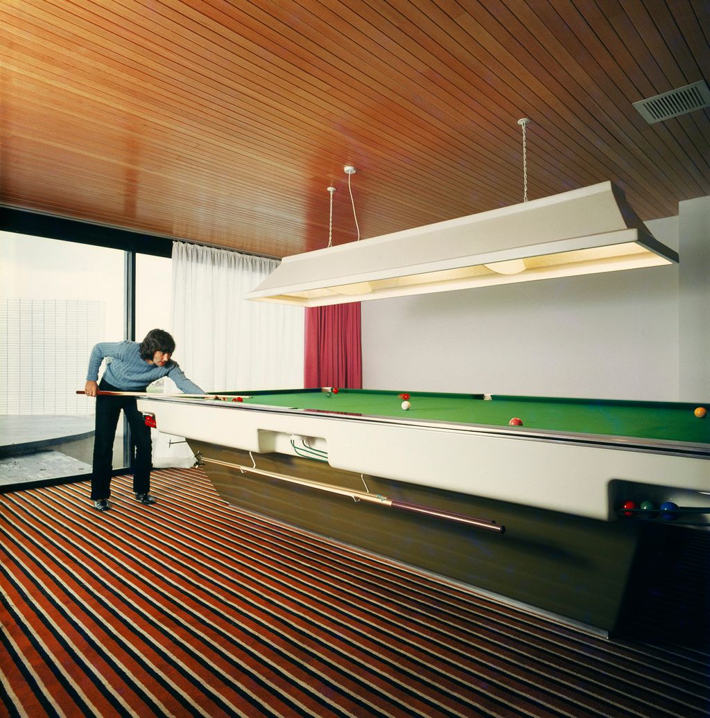 Image may contain Indoors Room Furniture Human Person Table George Best Billiard Room Banister and Handrail